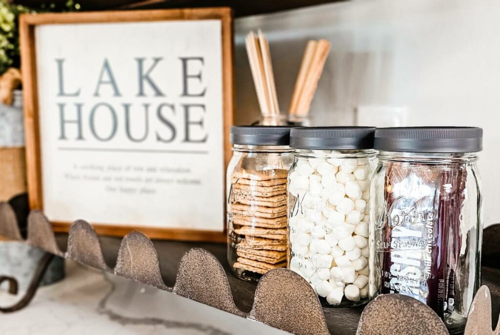 Lake house sign with jars of s'more ingredients